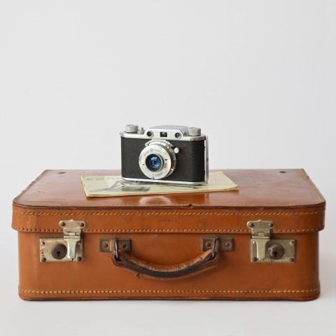 A suitcase and camera for travelling