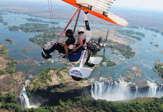 Tourists Microlighting over Victoria falls