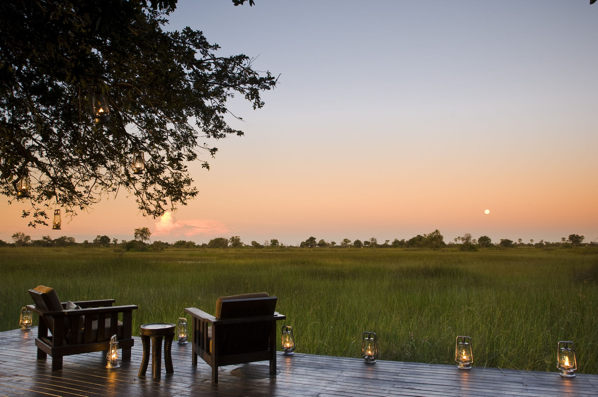 Nxabega Okavango Camp at sunset overlooking the floodplains