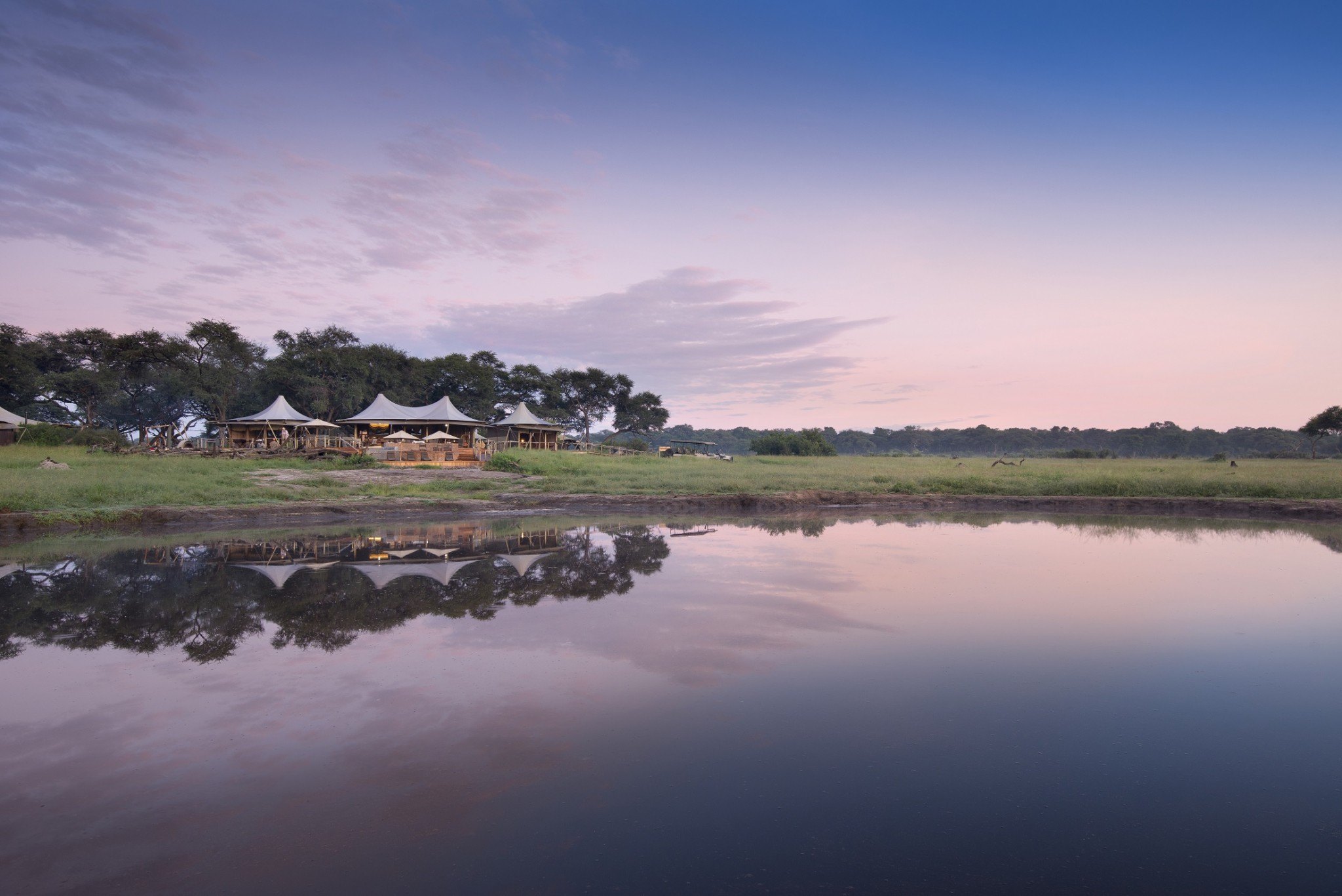 Visit Zimbabwe to admire a sunset like this one spotted at Somalisa Camp