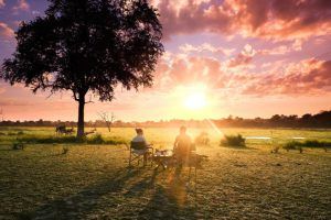 Couple enjoys colorful sunrise in Tanzania