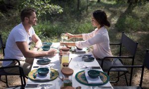 A couple is enjoying their breakfast in the South African bush at Silvan Safari