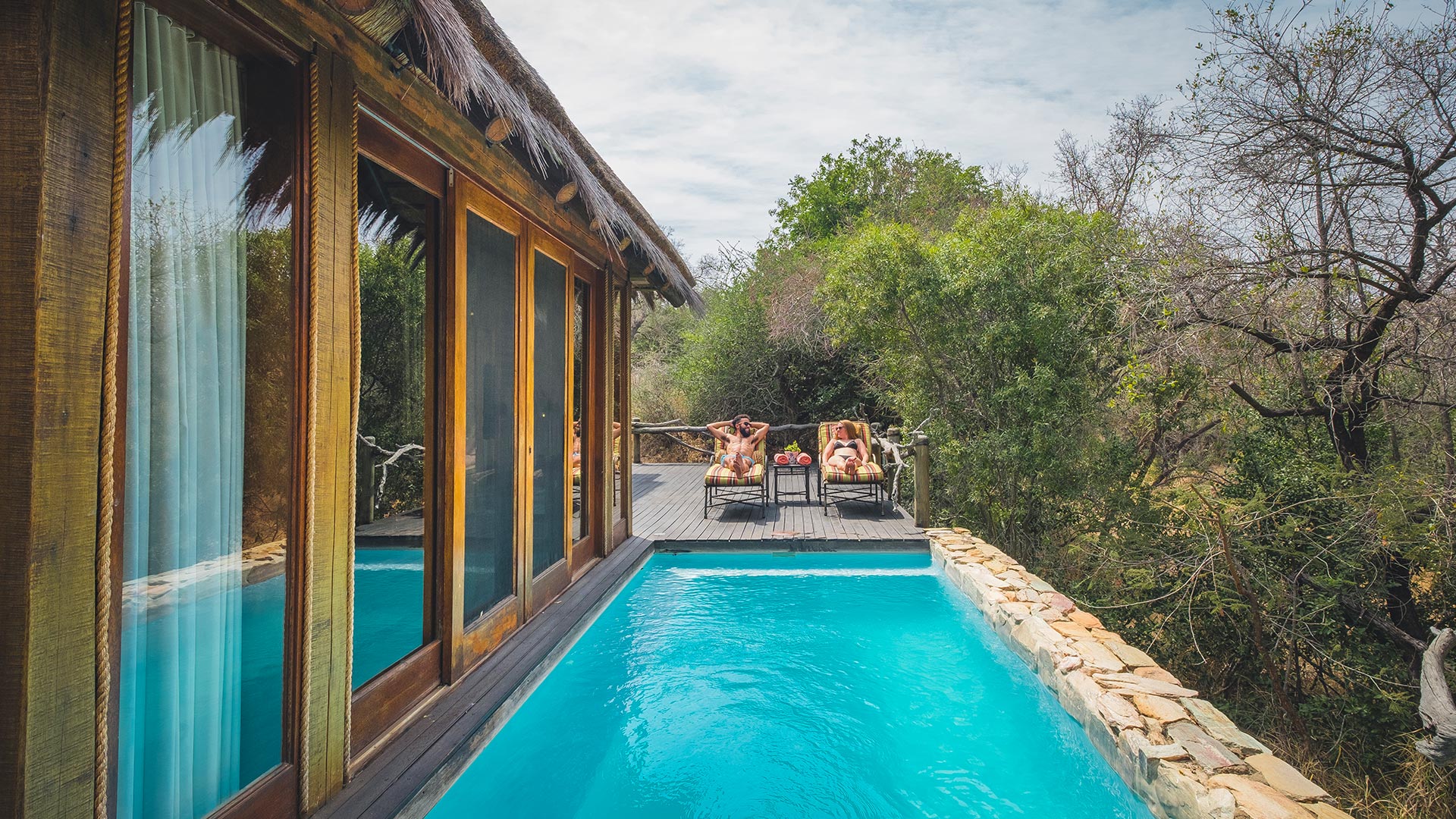 two people relaxing at a private plunge pool at Jabulani lodge