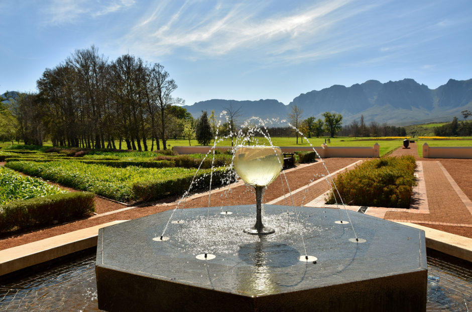 Landscape with a water fountain with a wine glass