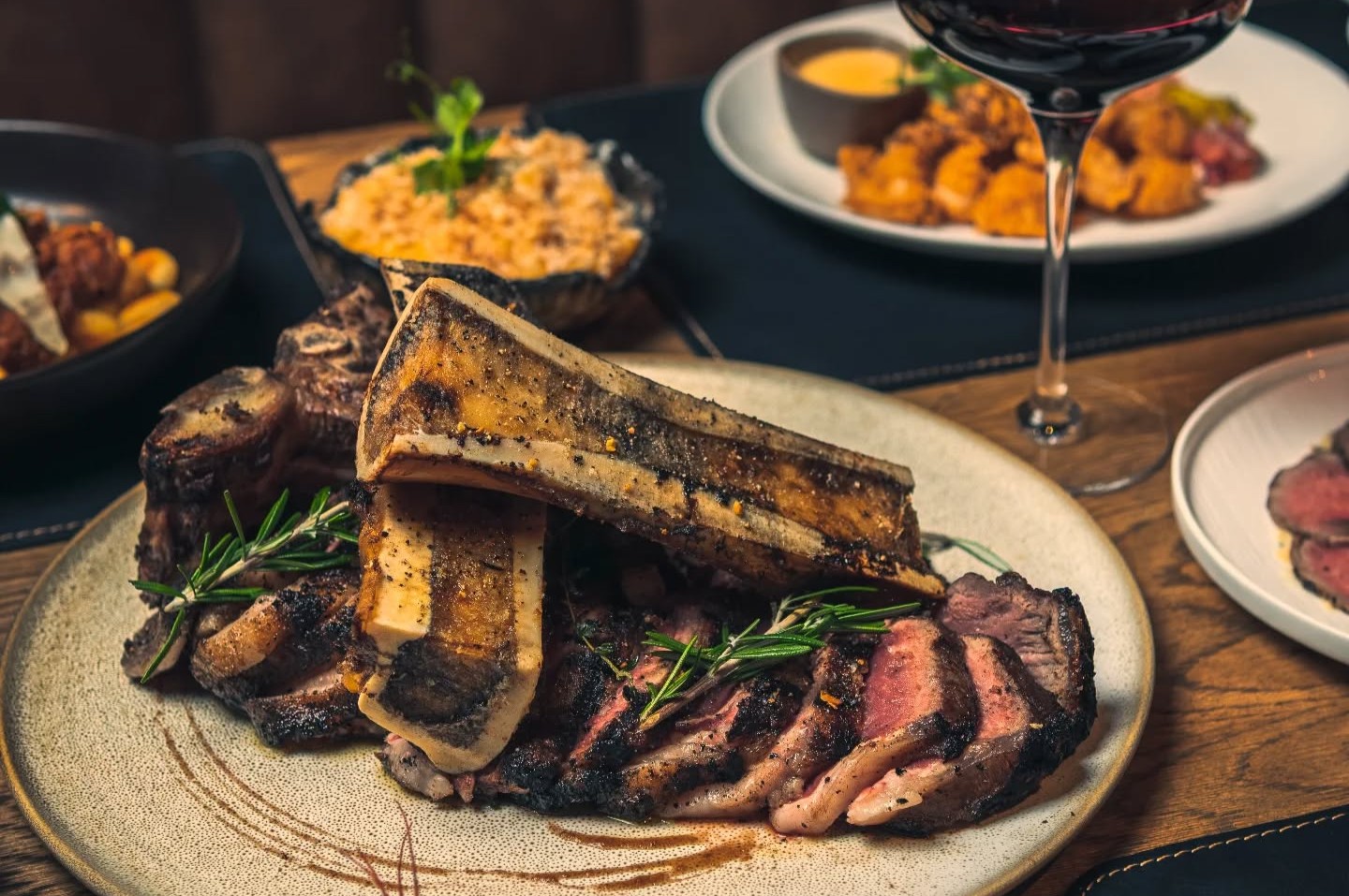 500097818_18027748613675375_7345510747612605911_n A restaurant table with sliced steak and complimentary dishes