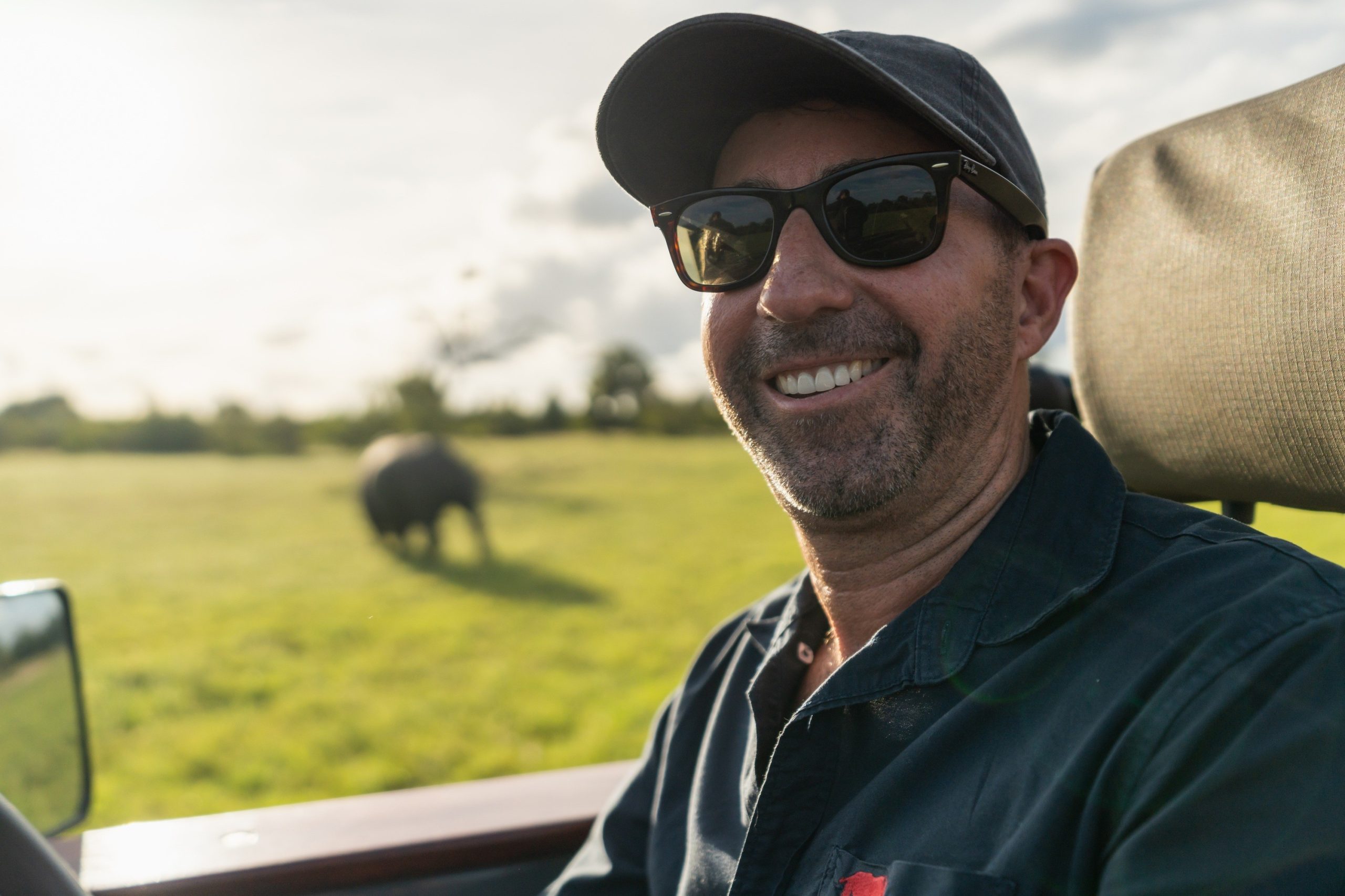 david-at-silvan-safari-copyrights-rhino-africa-019 (1) - Edited Rhino Africa CEO, David Ryan, photographed sitting in a game drive vehicle with an elephant in the background