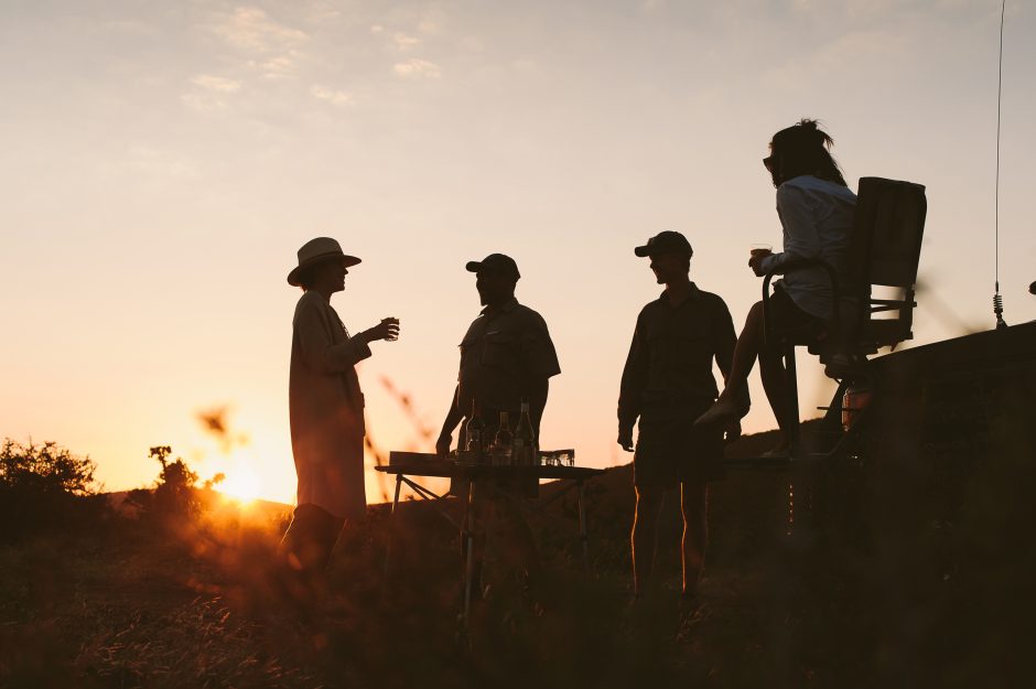 People enjoying sundowners on a sustainable safari at Kwandwe Private Game Reserve