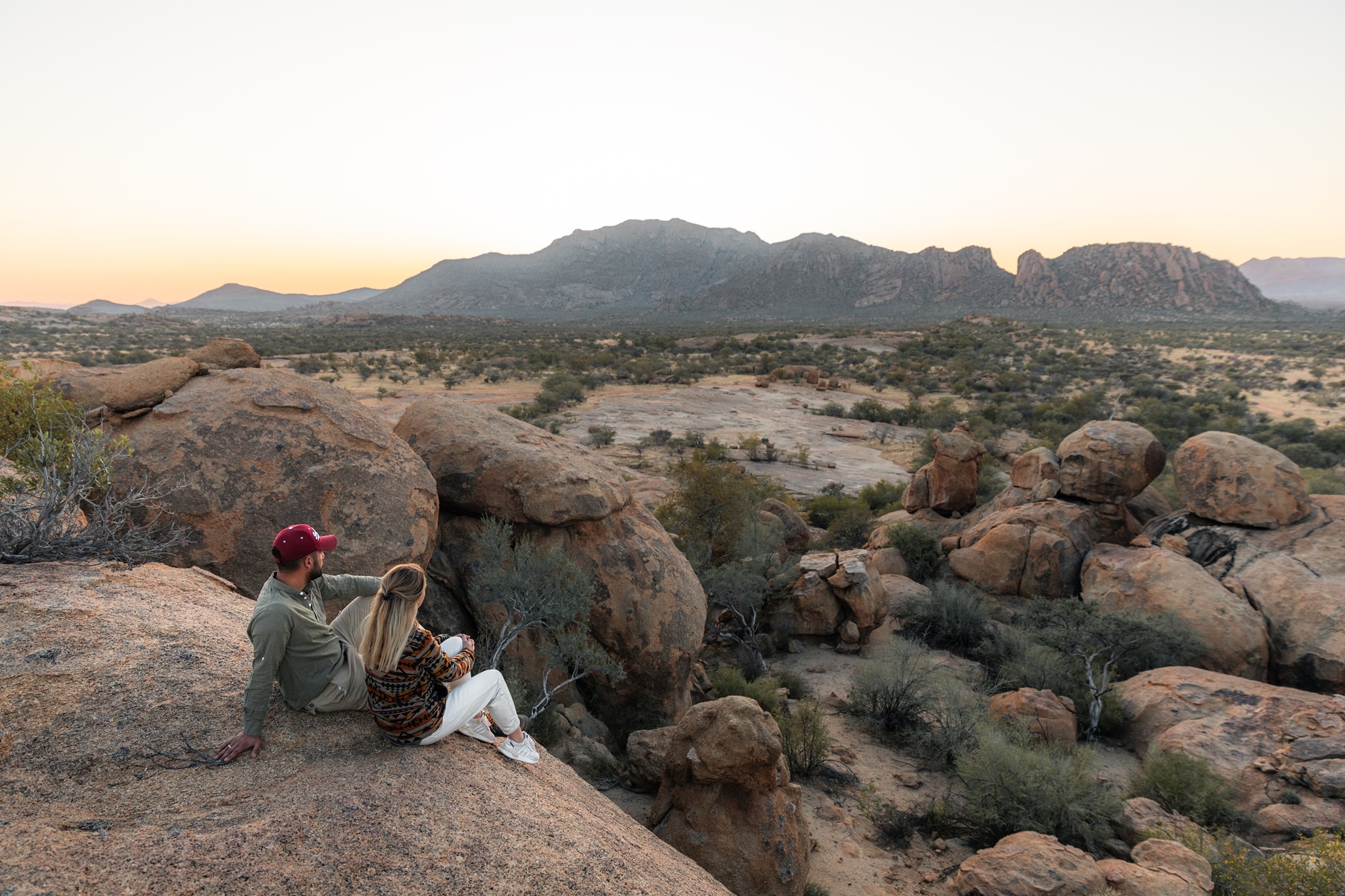 ai-aiba-rock-painting-lodge Couple looking out at the view in Namibia