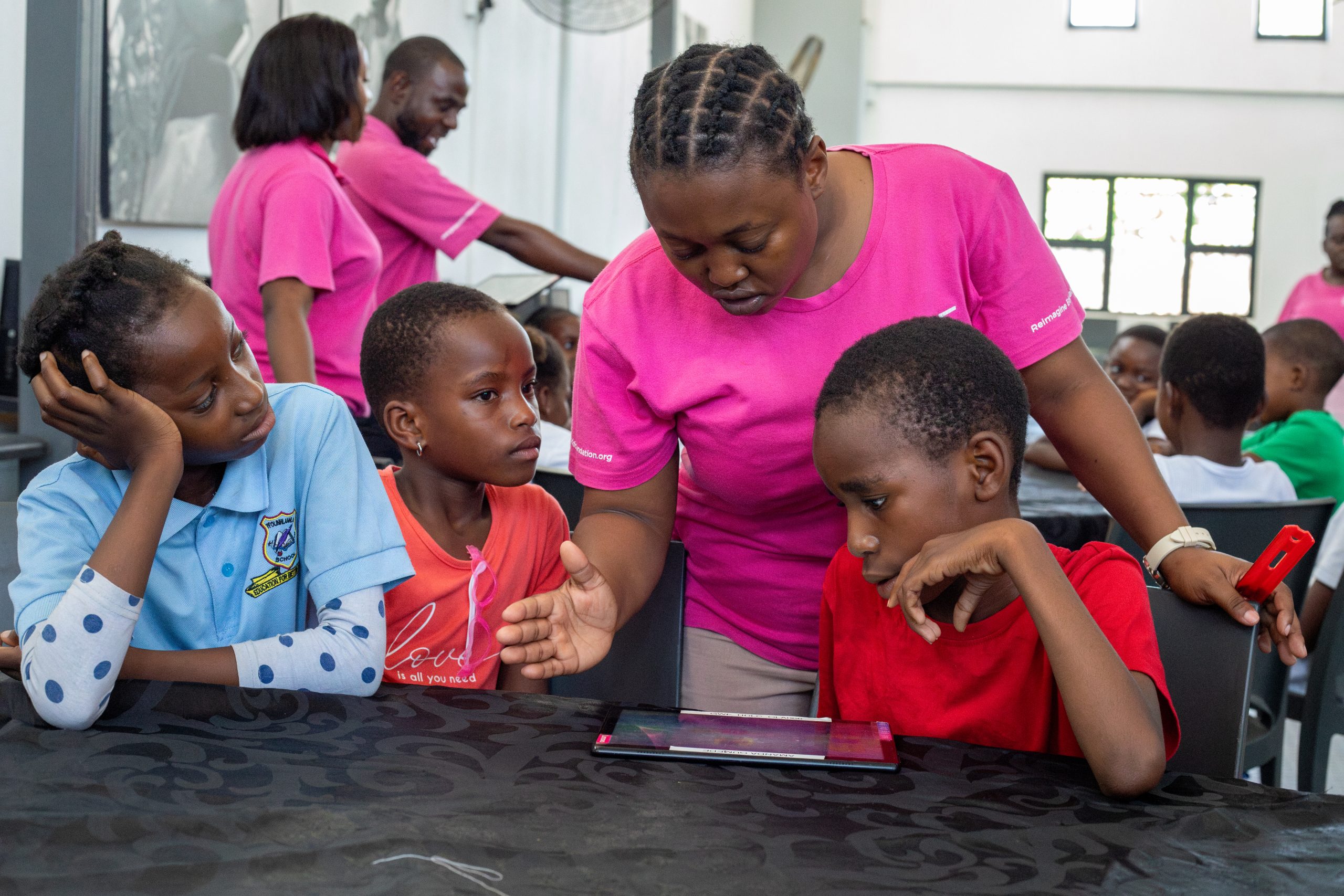 rhino-africa-marketing-team-visit-at-gwf-29 A facilitator at the Good Work Foundation’s Hazyview campus assisting young learners with a tablet-based activity.