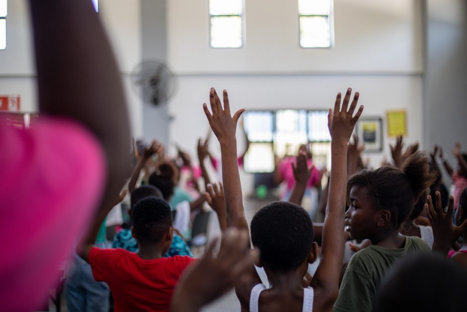 rhino-africa-marketing-team-visit-at-gwf-44 Students at the GWF Hazyview campus raise their hands in active engagement with their facilitator during a classroom session.