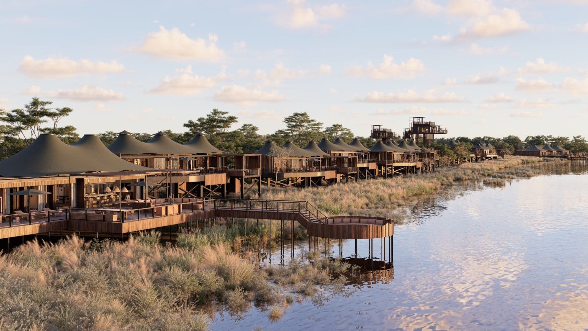 Anantara Kafue River Tented Camp A line of elevated tented suites stretches along the riverbank, their canvas roofs glowing in soft light as part of one of the new luxury safari lodges 2026.
