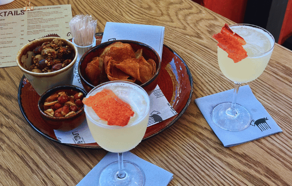 Cocktals and snacks with free-flowing conversation at Unclaimed Bar in Cape Town