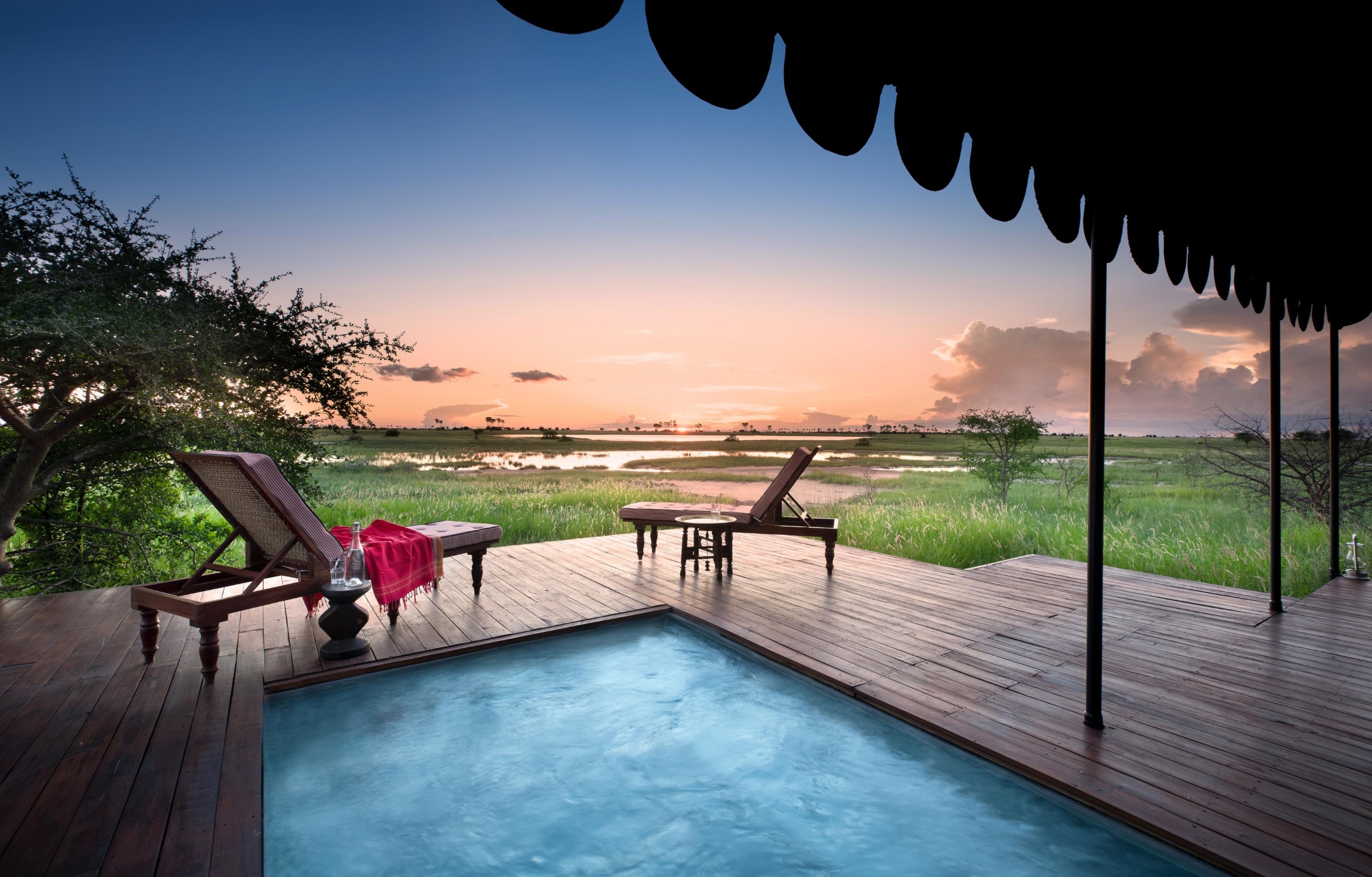 A private deck with a plunge pool overlooks a flooded grassland at sunset, closing on another view of where to go in 2026.