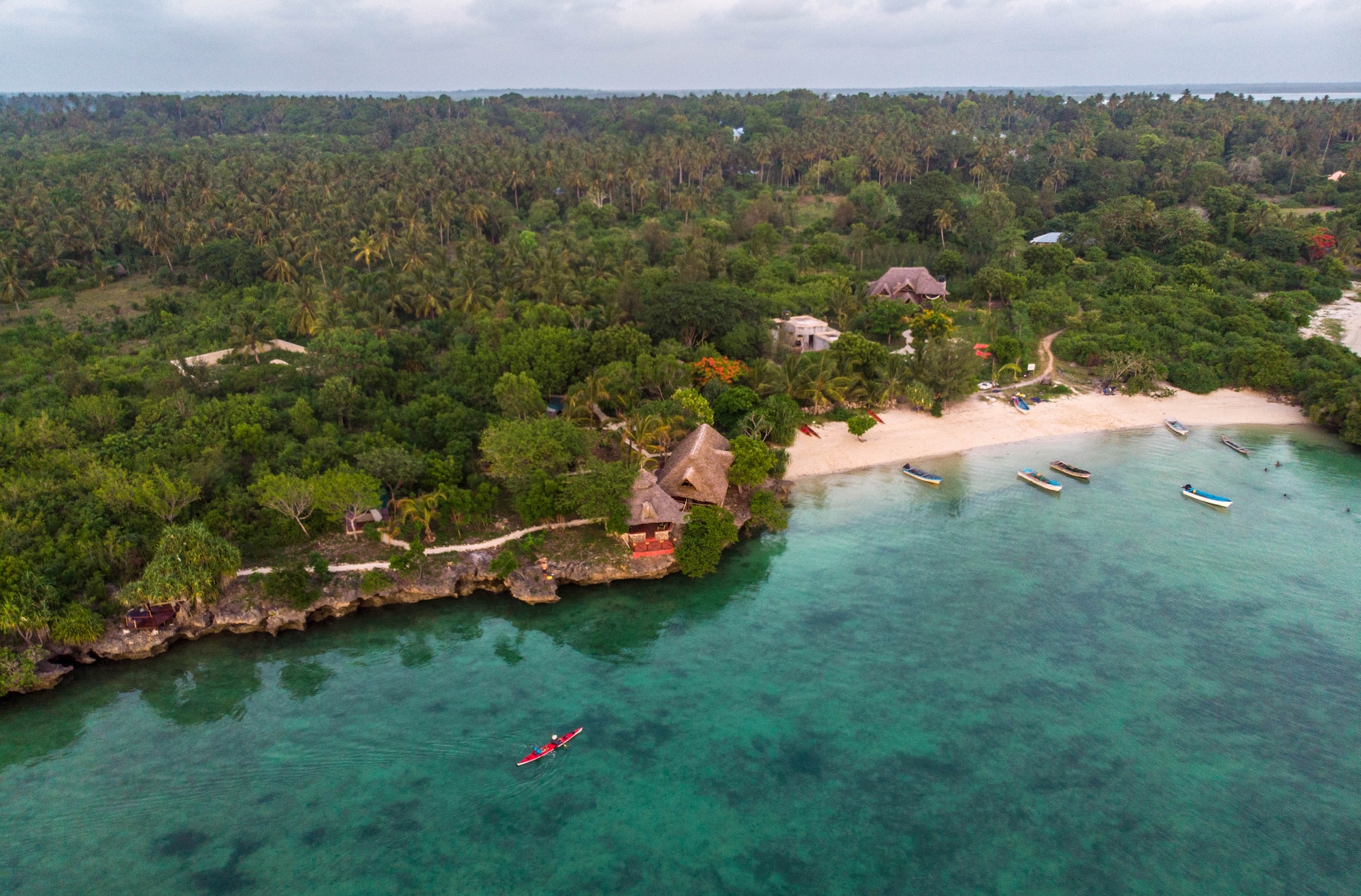 DJI_0016 A kayak glides on blue ocean waters towards the shore of Zanzibar, one of the best East Africa holiday destinations.