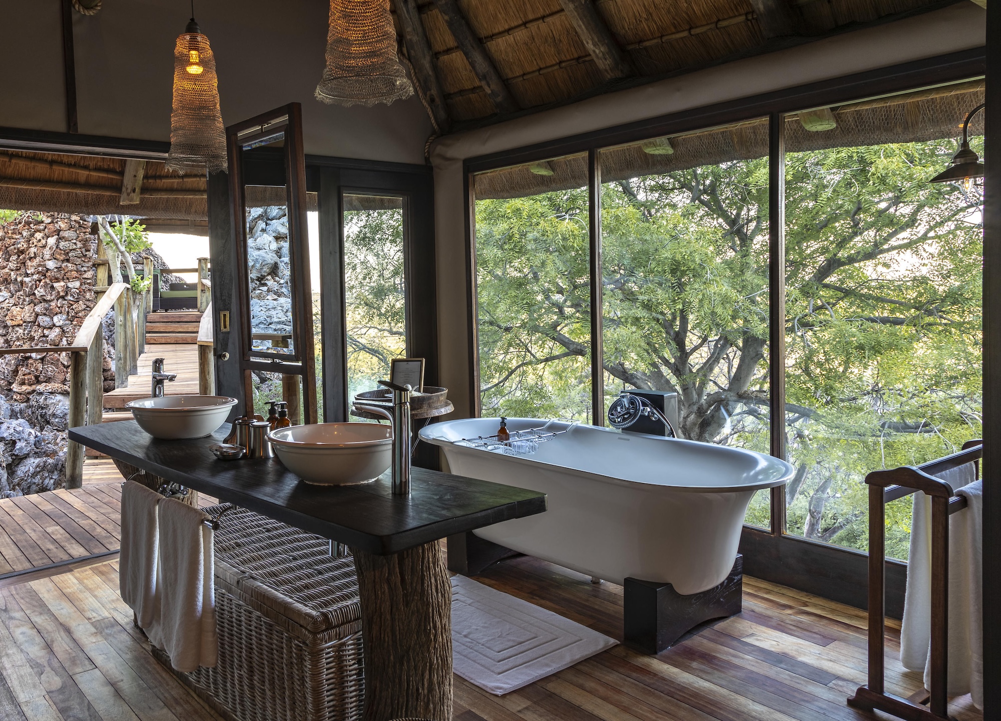 1759744274583lolongavaventure-medialvs--7 A stand alone bathtub in a luxury safari lodge in Namiba with trees outside the window