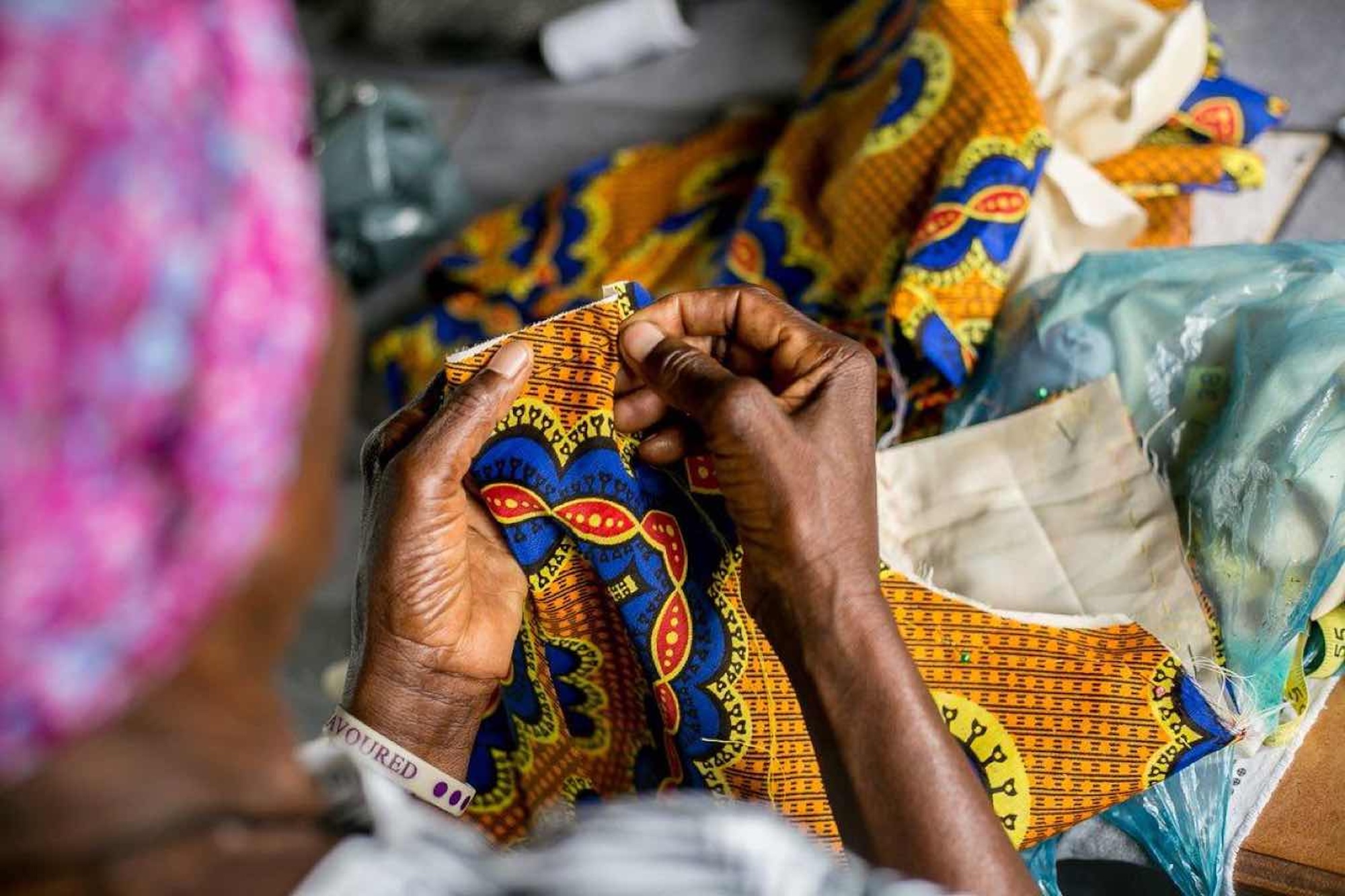 A woman sewing traditional clothing and items in Zimbabwe