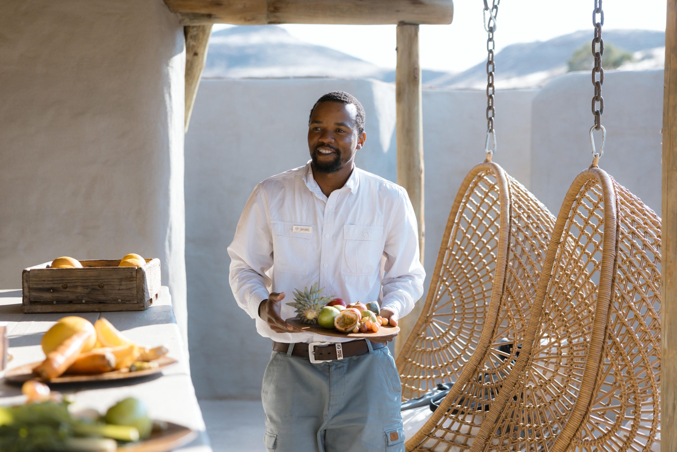 A staff member bringing out fresh fruit at a lodge in Namibia