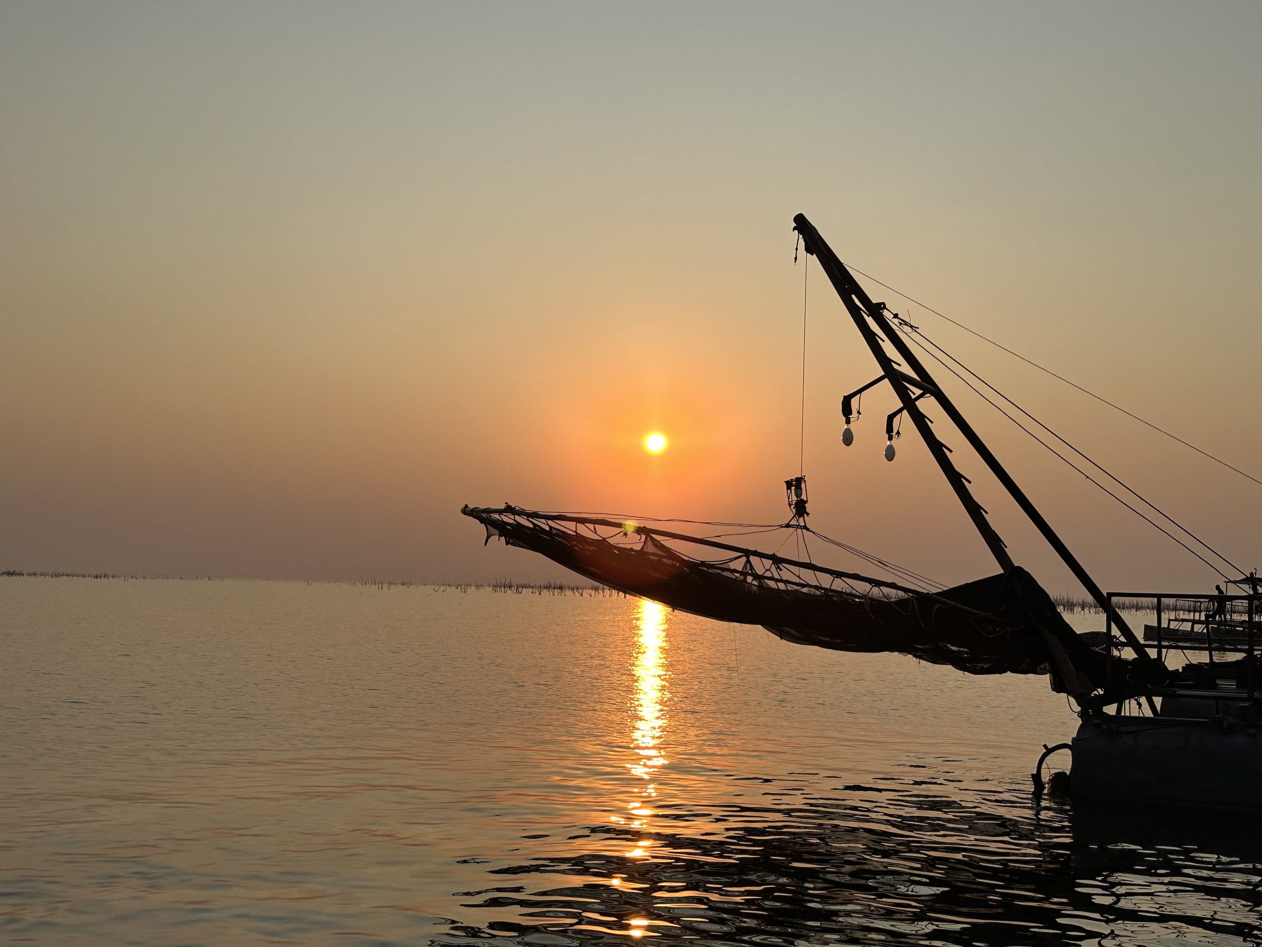 A boat silhouetted against sunset on Lake Kariba during a Zimbabwe safari.
