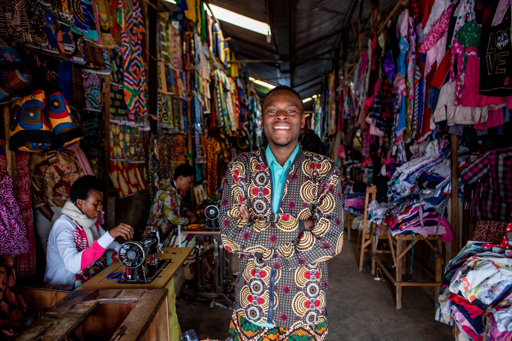 A man stands dressed in traditional African patterned clothing, one of the many ways Kigali in Rwanda dazzles.