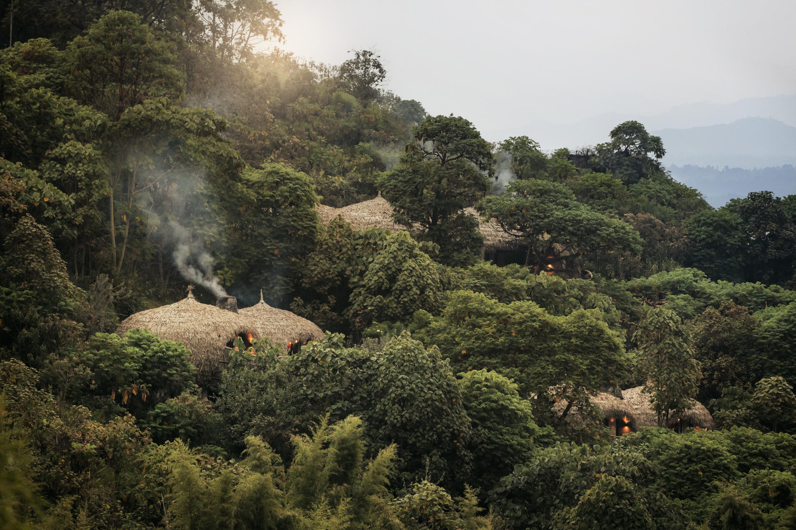 A lodge perched on the slopes of a hill neighboring Volcanoes National Park, as seen on a Rwanda safari